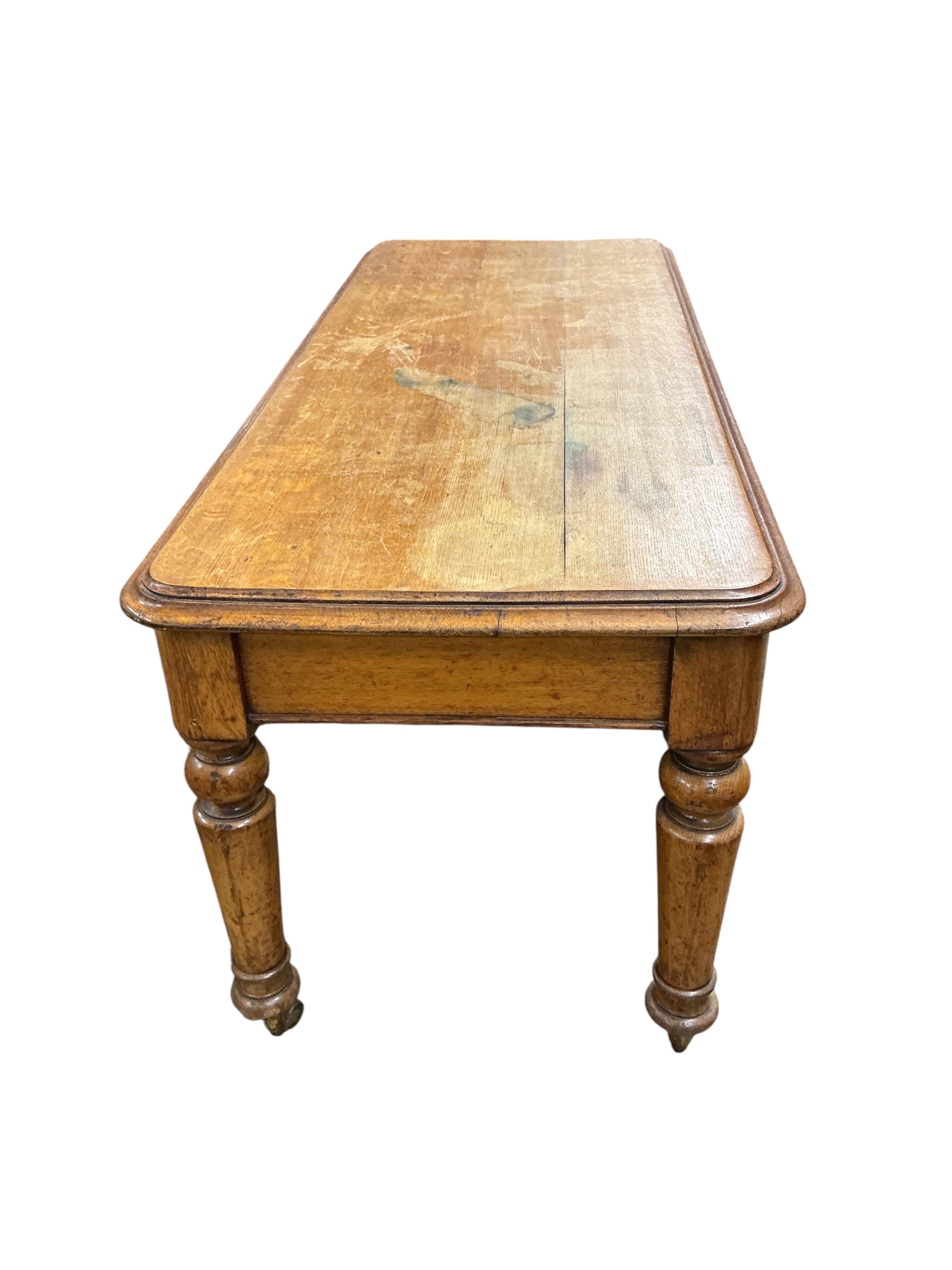 A Victorian light oak side table, fitted two drawers, on turned legs, width 180cm, depth 74cm, height 80cm